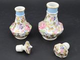 three pieces of porcelain vases with flowers on them