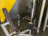 a gym equipment sitting in a room with a yellow wall