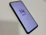 a close up of a phone on a table with a logo on the screen
