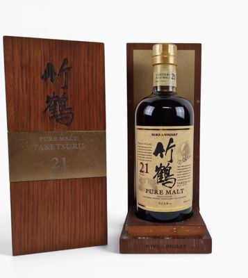a bottle of japanese whisky sitting on top of a wooden box
