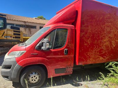 a red truck that is parked next to a building