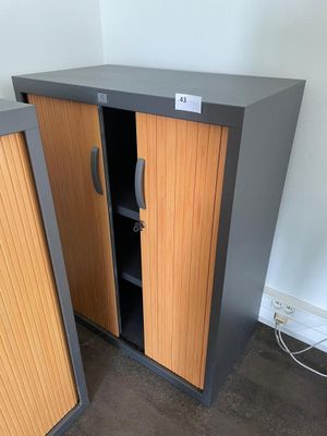 pair of metal and wood storage cabinets in a room