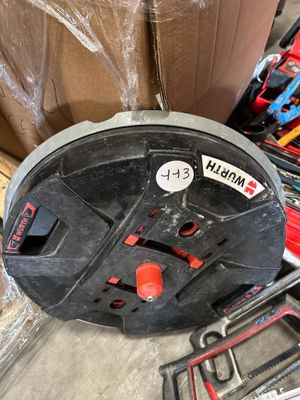 a box of tools sitting on the floor next to a pile of boxes
