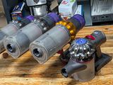 several different types of vacuums on a wooden table in a room