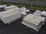 a lot of white bricks on a pallet in the parking lot