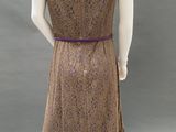 a mannequin wearing a brown dress with a purple belt