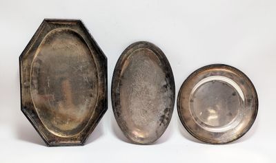 three silver plated objects are sitting next to each other on a white surface