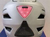a white helmet with a red light on top of it