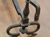 an old iron bench with a wooden seat on the floor