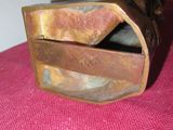 a small wooden box that is on a pink table