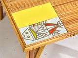 a small table with a fish design on the top of it
