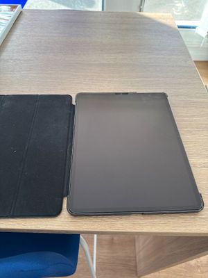 two tablet computers sitting on a table next to each other