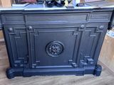 a black stove sitting in the corner of a room
