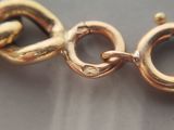 a close up of a gold chain on a table
