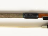 a close up of a violin bow and a violin stick