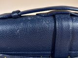 a close up of a blue purse with a zipper on it