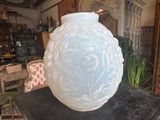 a white vase sitting on top of a black table