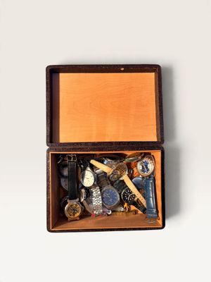a wooden box filled with assorted items on a white surface