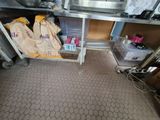 a kitchen with a sink and a counter with bags of food in it