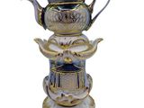 a blue and white vase with a bird on top of it