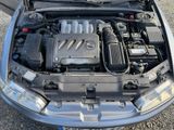 the engine of a car with its hood open on the ground