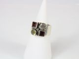 a close up of a ring on a white cone on a white surface