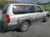 a silver suv that is parked in a parking lot