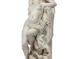 marble statue of a woman sitting on a rock with a horse