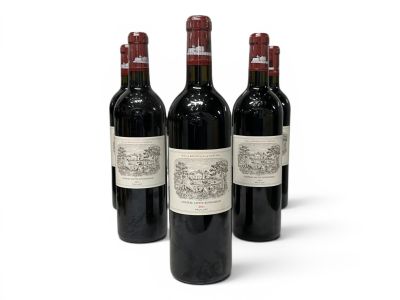three bottles of red wine are lined up on a white surface