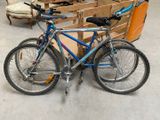 a bike that is parked in front of a chair