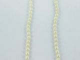 a white pearl necklace with a gold clasp