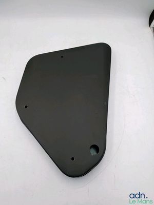 a close up of a black plate on a white surface
