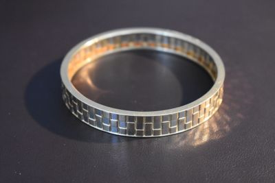 a close up of a silver ring on a table