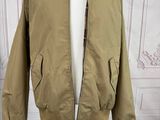jacket on a mannequin stand in front of a white wall