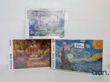 three cards with paintings on them sitting on a white surface