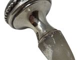 a metal object that is sitting on a white surface