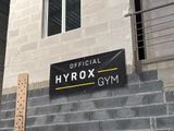 a sign on the side of a building that says hyrox gym