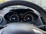 dashboard view of a car with a steering wheel and gauges