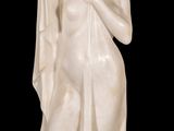 statue of a woman holding a bird on a black background