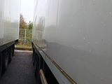 two large semi trucks parked side by side on the street