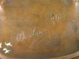 a close up of a bronze plate with writing on it