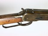 an old rifle with a wooden handle on a white background