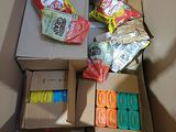 a box full of snacks and candy sitting on the floor