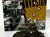 a toy army vehicle and a book on a table
