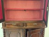 a wooden cabinet with a red checkered cloth on it
