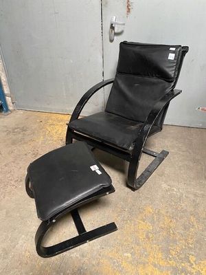 an image of a black chair and ottoman in a room