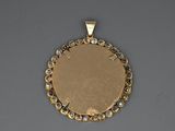 a close up of a gold plated pendant with clear stones