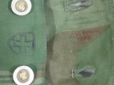 a close up of a green bag with buttons on it