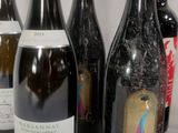 several bottles of wine are lined up on a table