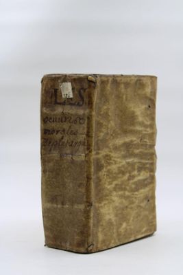 an old book sitting on top of a table next to a white background